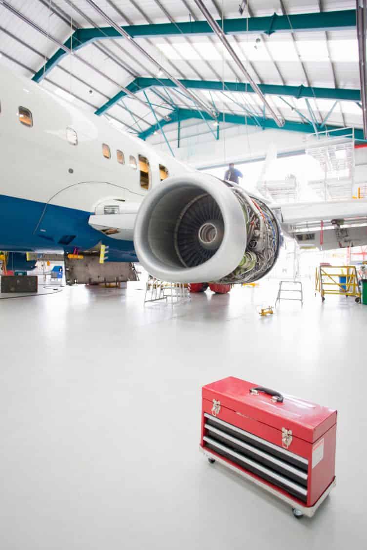 Light-gray resinous coating on an aircraft maintenance hangar floor.