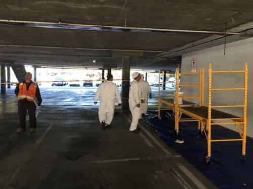 Carbon fiber reinforcement bonded across a concrete member in a parking structure.