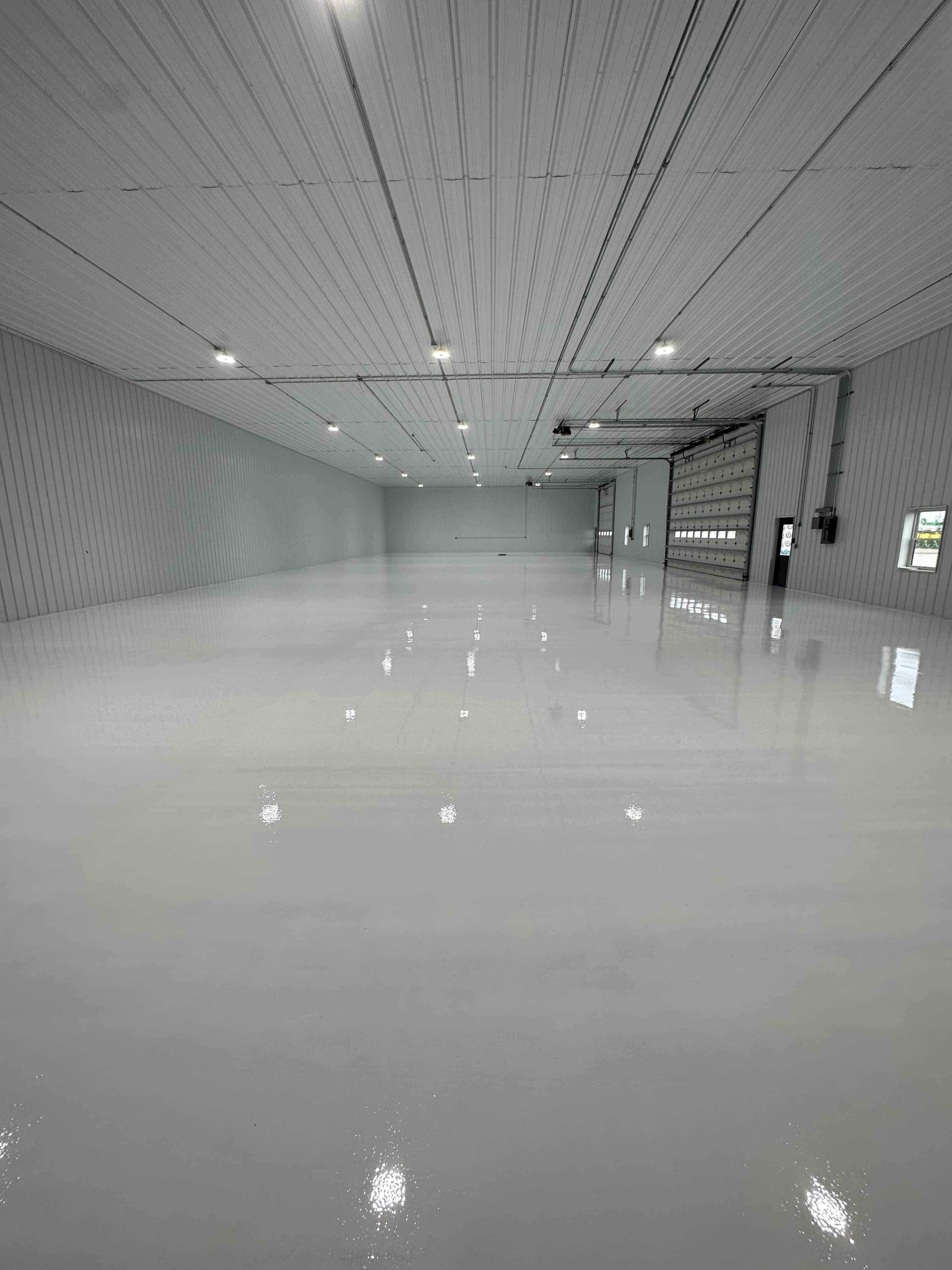 A finished high-gloss resinous floor coating installed to the manufacturer's published method.
