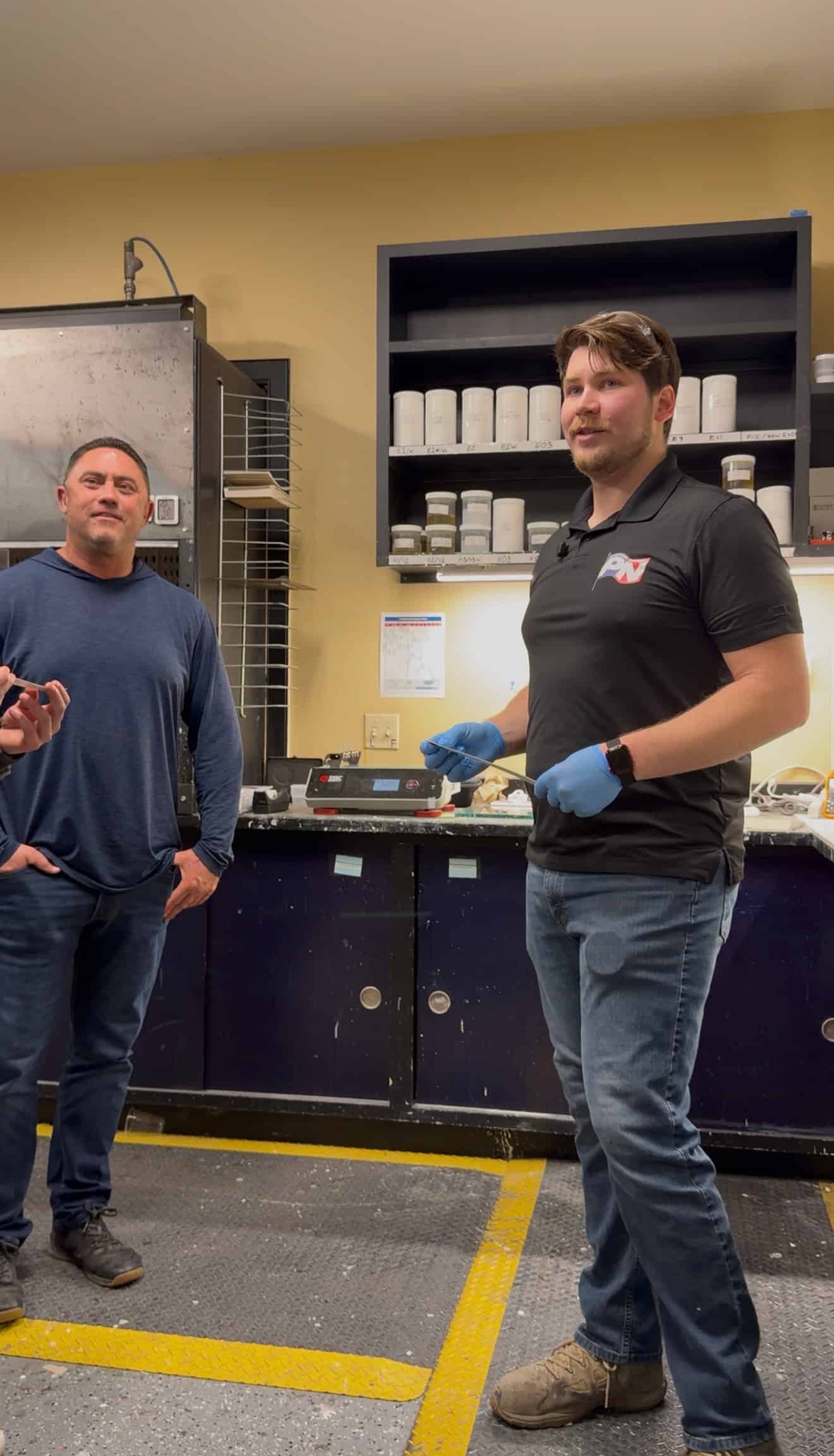 Salyers reviewing a resinous coating system with a Polymer Nation representative in the coatings lab.