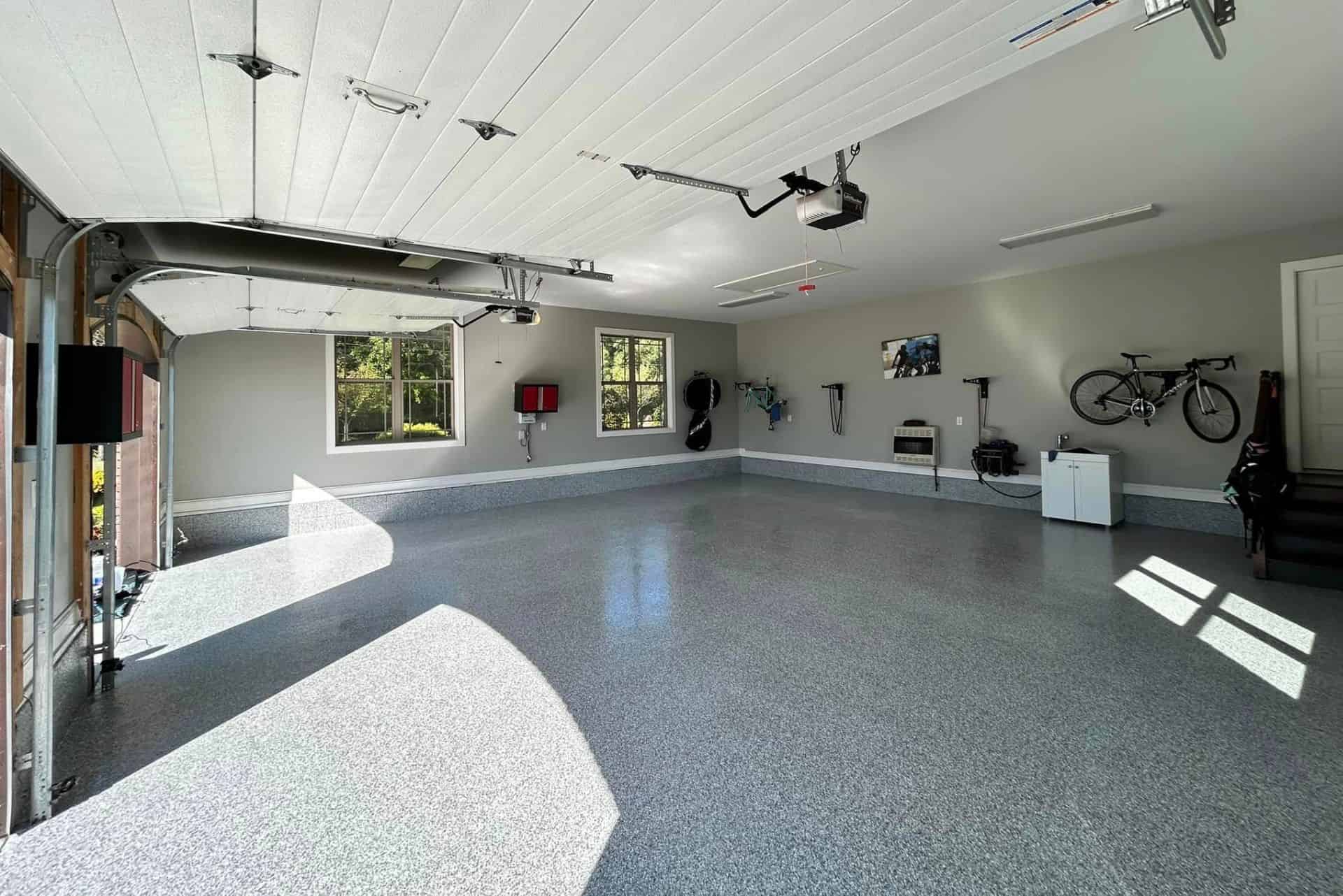 High-end residential garage finished with a decorative grey flake epoxy floor